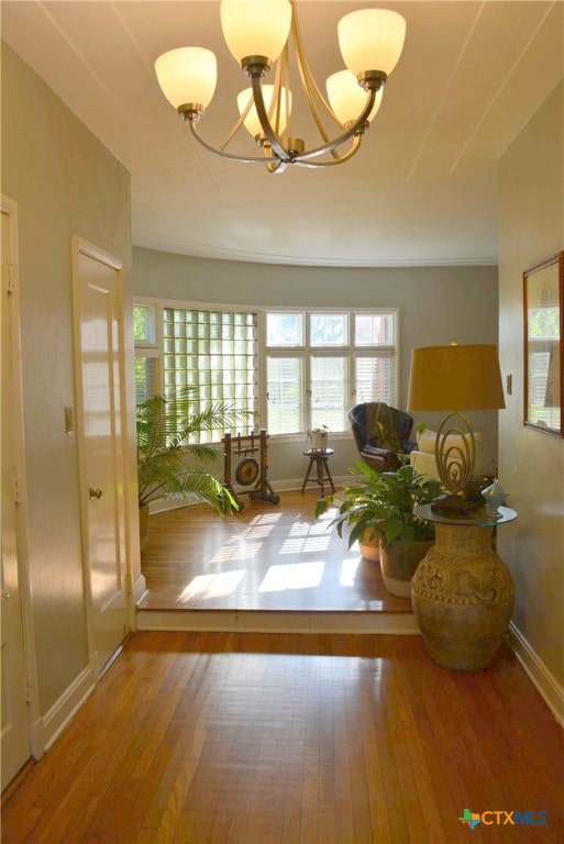 entryway featuring wood-type flooring and an inviting chandelier