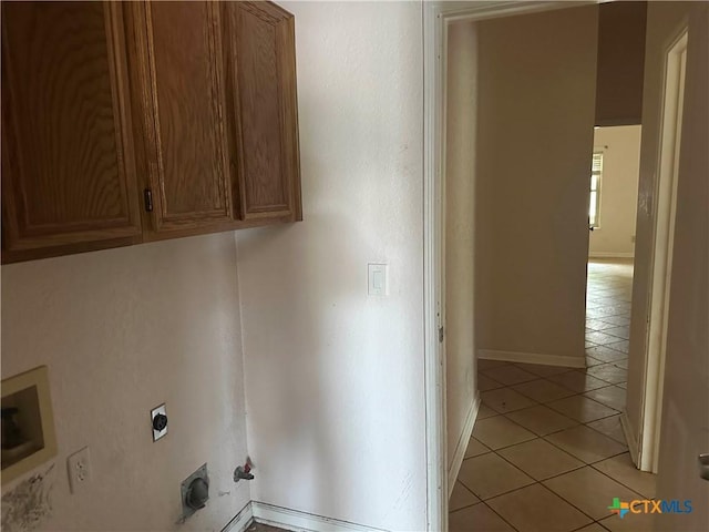 307 Illinois Dr, Harker Heights, TX 76548 - laundry area with electric dryer hookup, cabinet space, light tile patterned floors, baseboards, and gas dryer hookup