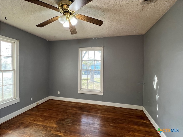 unfurnished room featuring a textured ceiling, dark hardwood / wood-style floors, and ceiling fan