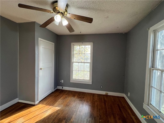1215 S 47th St, Temple, TX 76504 - empty room featuring a textured ceiling, hardwood / wood-style floors, baseboards, and ceiling fan