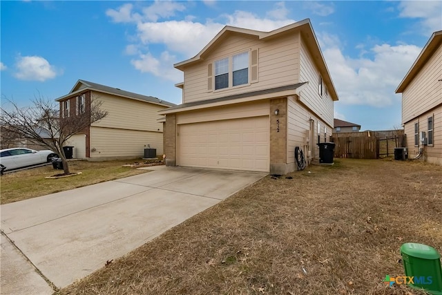 view of side of property featuring a garage, central AC unit, and a lawn