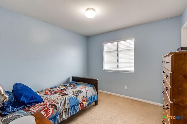 bedroom featuring light carpet