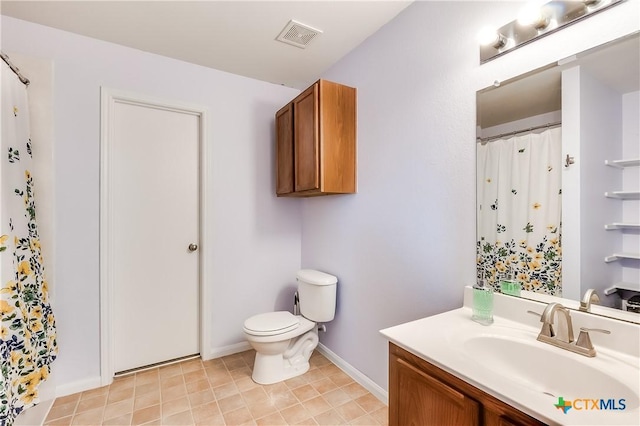 bathroom with vanity, toilet, and curtained shower