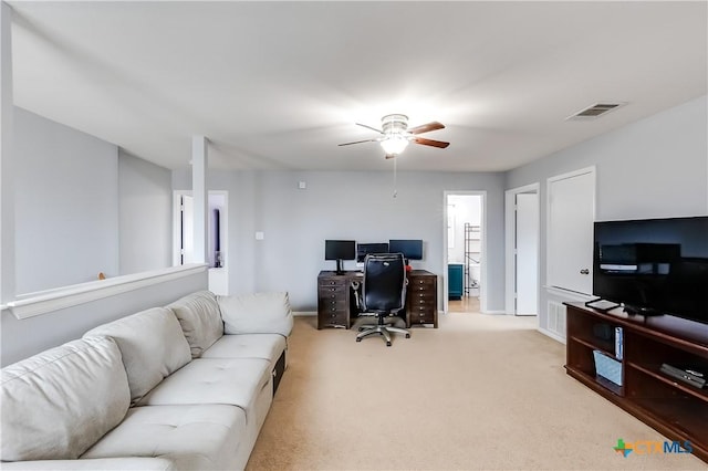 carpeted office space with ceiling fan