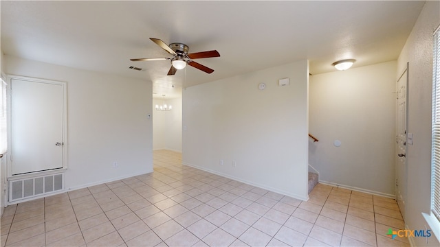 empty room with light tile patterned floors and ceiling fan