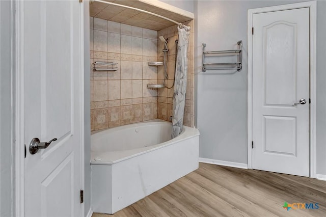 bathroom featuring shower / tub combo with curtain and hardwood / wood-style flooring