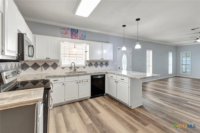 kitchen with white cabinets, appliances with stainless steel finishes, kitchen peninsula, and sink