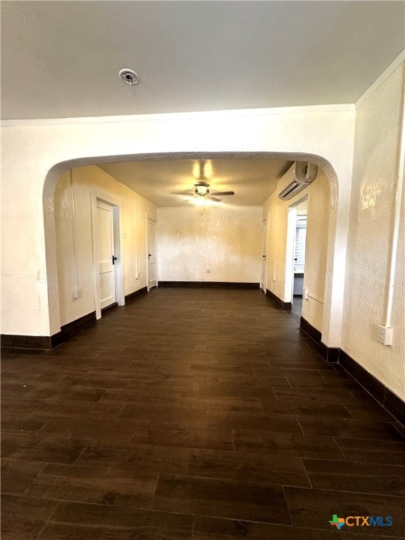 corridor featuring a wall unit AC and dark hardwood / wood-style floors