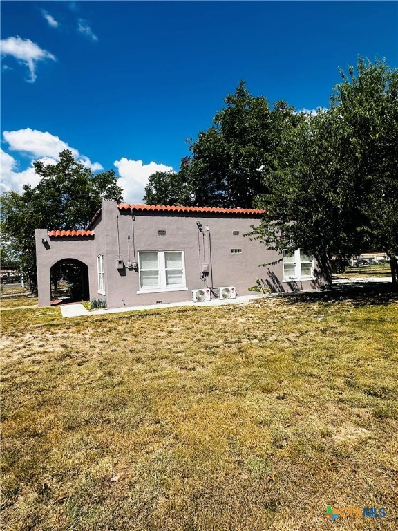 rear view of house featuring a lawn