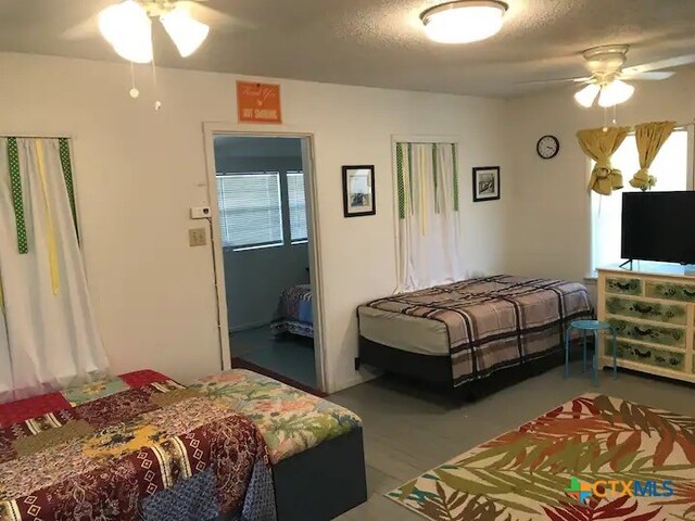 bedroom featuring a textured ceiling and ceiling fan