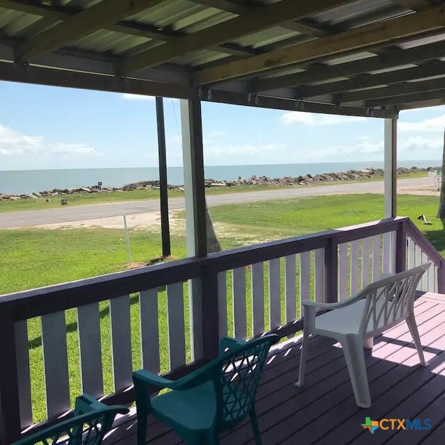 deck featuring a lawn and a water view