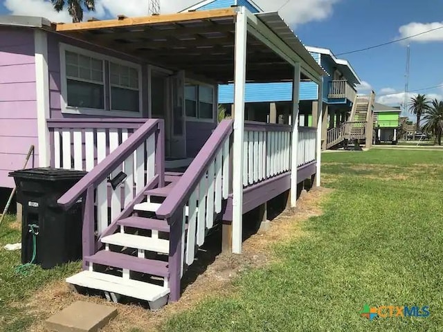 296 S Ocean Dr, Port Lavaca, TX 77979 - wooden terrace featuring a lawn and stairway