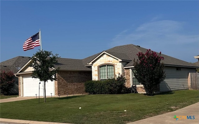 1205 Abbey Rdg, Temple, TX 76504 - view of front of house featuring driveway, a front lawn, brick siding, and a garage