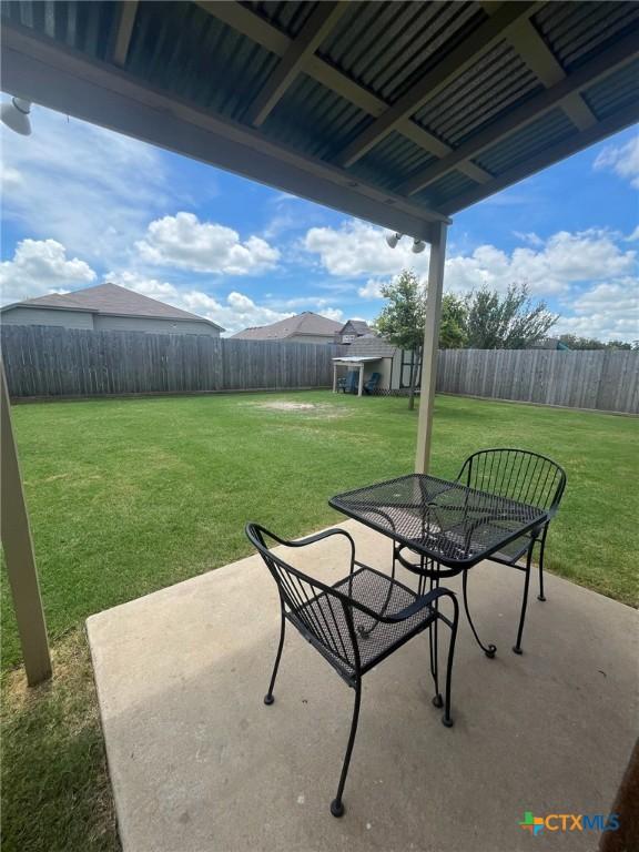 1205 Abbey Rdg, Temple, TX 76504 - fenced backyard with a patio and outdoor dining space