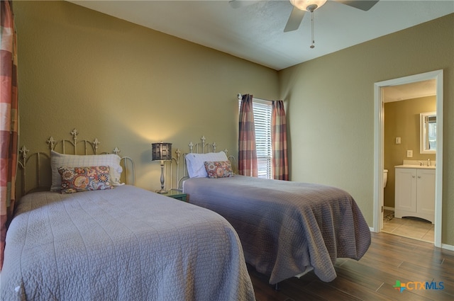 bedroom featuring ceiling fan, sink, and ensuite bathroom