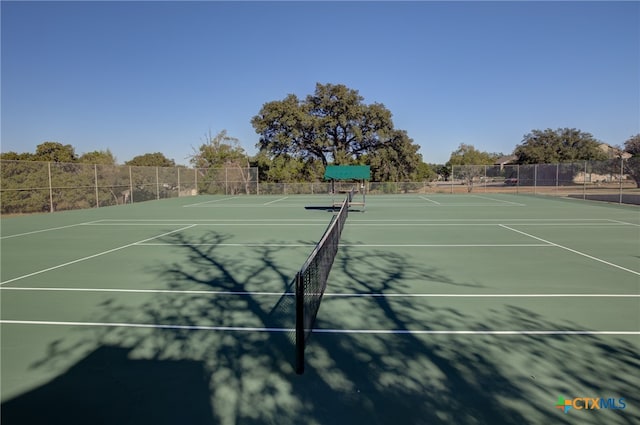 view of tennis court with basketball hoop