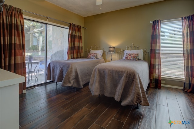 bedroom featuring multiple windows, access to exterior, and ceiling fan