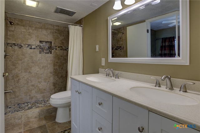 bathroom with toilet, vanity, and a shower with shower curtain