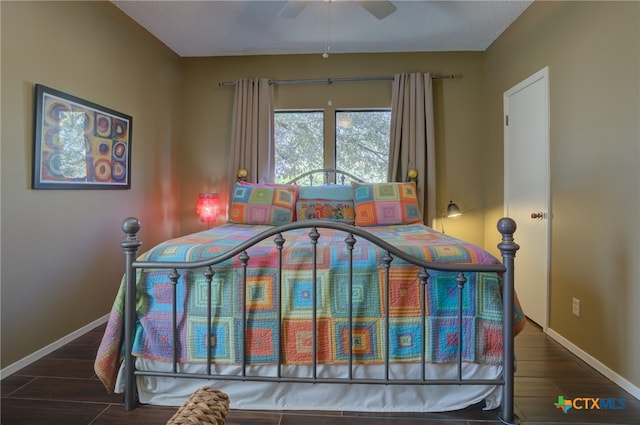 bedroom with ceiling fan and dark hardwood / wood-style flooring