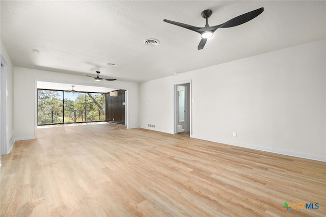 unfurnished room featuring a textured ceiling, ceiling fan, and light hardwood / wood-style floors