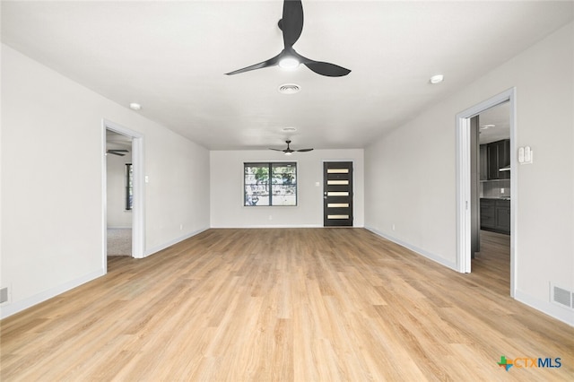 unfurnished living room with ceiling fan and light hardwood / wood-style flooring