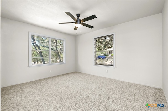 carpeted empty room featuring ceiling fan