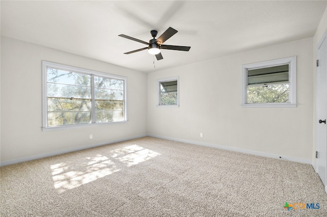 carpeted spare room with ceiling fan