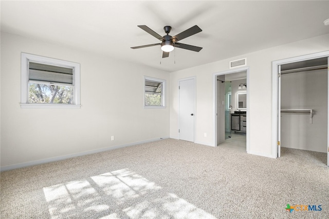 unfurnished bedroom with ceiling fan and light colored carpet