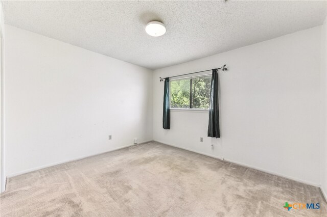 12219 Mosley Ln, Austin, TX 78727 - spare room with carpet flooring and a textured ceiling