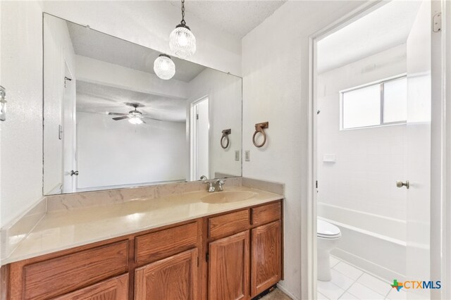 12219 Mosley Ln, Austin, TX 78727 - bathroom with vanity, a ceiling fan, tub / shower combination, and tile patterned floors