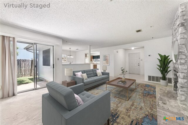 12219 Mosley Ln, Austin, TX 78727 - living room with a textured ceiling and carpet floors