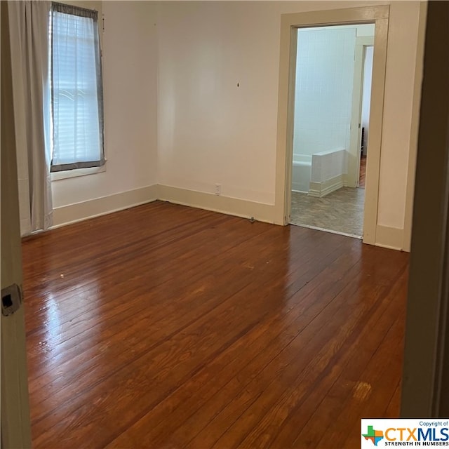 empty room featuring dark hardwood / wood-style flooring