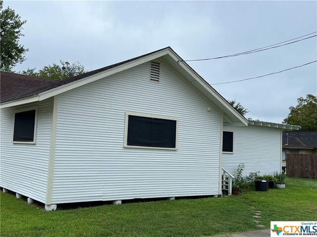 view of side of home featuring a yard