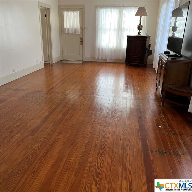 unfurnished living room featuring dark hardwood / wood-style floors