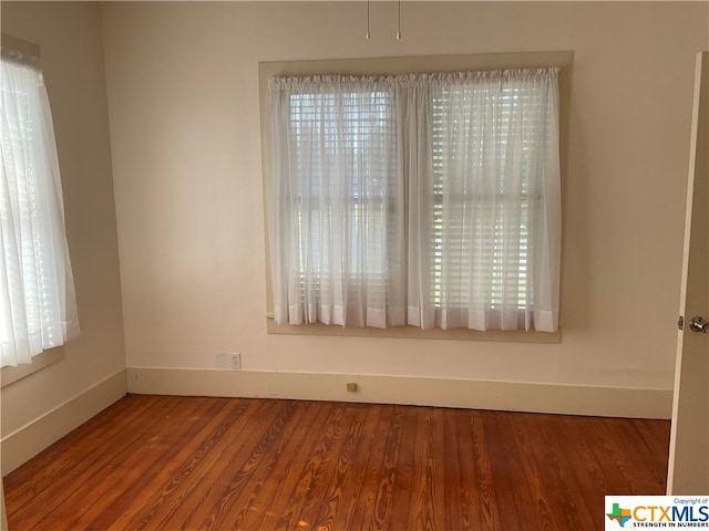 empty room featuring wood-type flooring