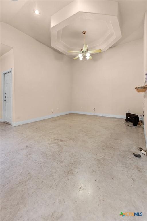 225 Anne Louise Dr, New Braunfels, TX 78130 - unfurnished living room featuring a ceiling fan, concrete flooring, a raised ceiling, and recessed lighting