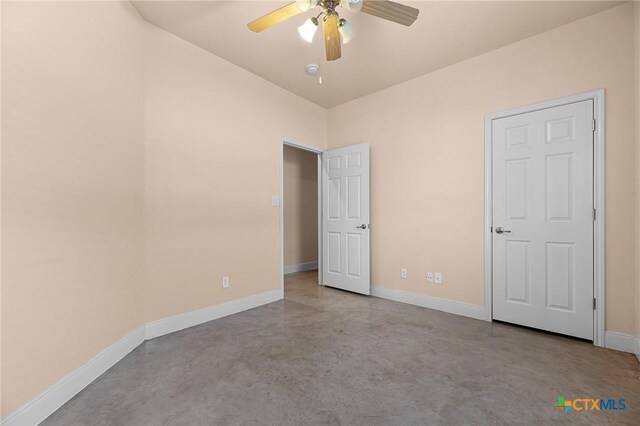 225 Anne Louise Dr, New Braunfels, TX 78130 - unfurnished bedroom featuring concrete flooring and ceiling fan