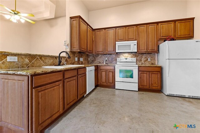 225 Anne Louise Dr, New Braunfels, TX 78130 - kitchen featuring white appliances, brown cabinetry, decorative backsplash, ceiling fan, and light stone counters