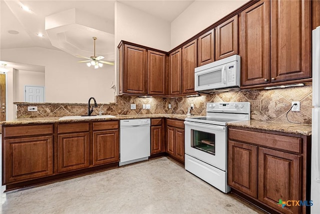 225 Anne Louise Dr, New Braunfels, TX 78130 - kitchen with white appliances, ceiling fan, a peninsula, stone countertops, and tasteful backsplash