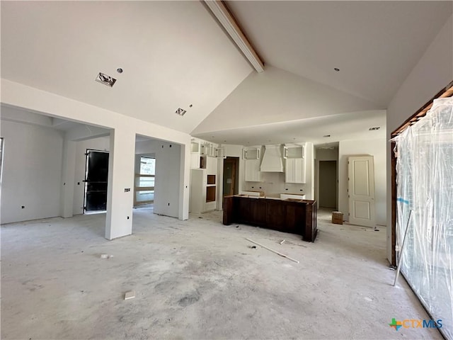 kitchen with white cabinets, custom range hood, high vaulted ceiling, beamed ceiling, and a kitchen island