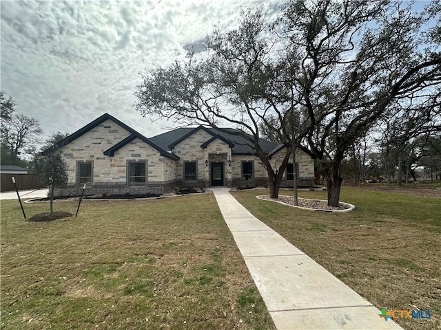 french provincial home with a front yard