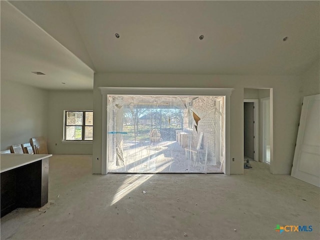 doorway to outside with lofted ceiling