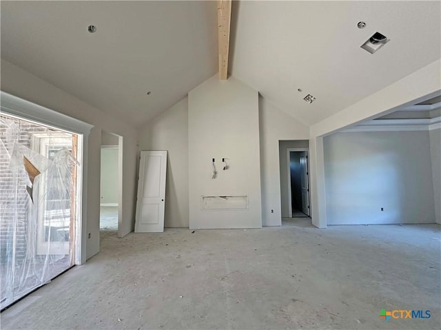 empty room featuring beamed ceiling and high vaulted ceiling