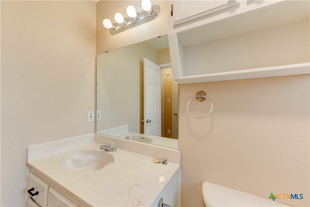 bathroom with vanity and toilet