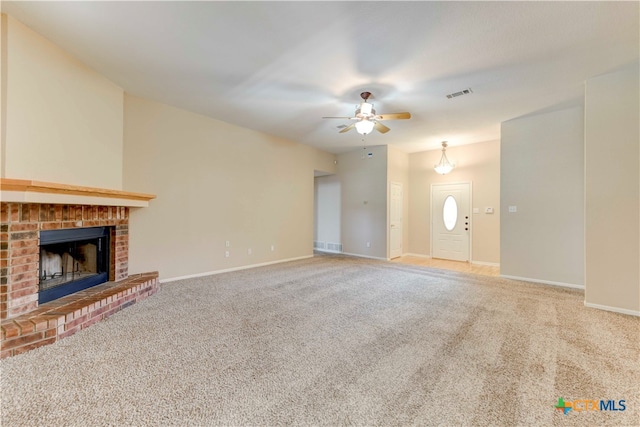 unfurnished living room featuring carpet flooring, ceiling fan, and a fireplace