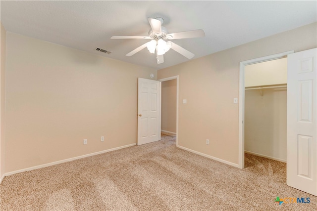 unfurnished bedroom with ceiling fan, a closet, and light colored carpet