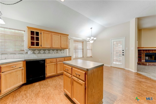 kitchen featuring vaulted ceiling, an inviting chandelier, black dishwasher, hanging light fixtures, and a kitchen island