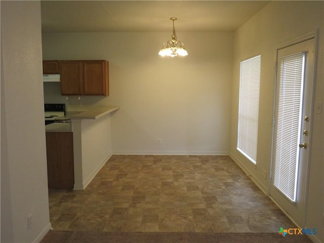 unfurnished dining area with a chandelier