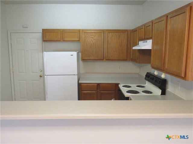 kitchen with white refrigerator and electric range oven