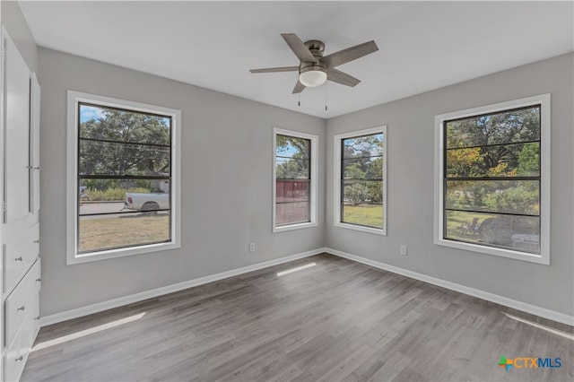 empty room featuring ceiling fan and light hardwood / wood-style floors